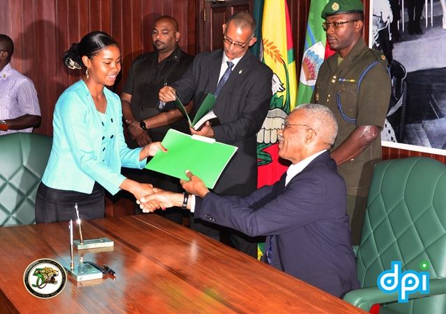 Eighteen year old Maxine Ann Welch, the Deputy Mayor of Lethem, Upper Takutu- Upper Essequibo (Region Nine) receiving her Instrument of Appointment from President David Granger. 